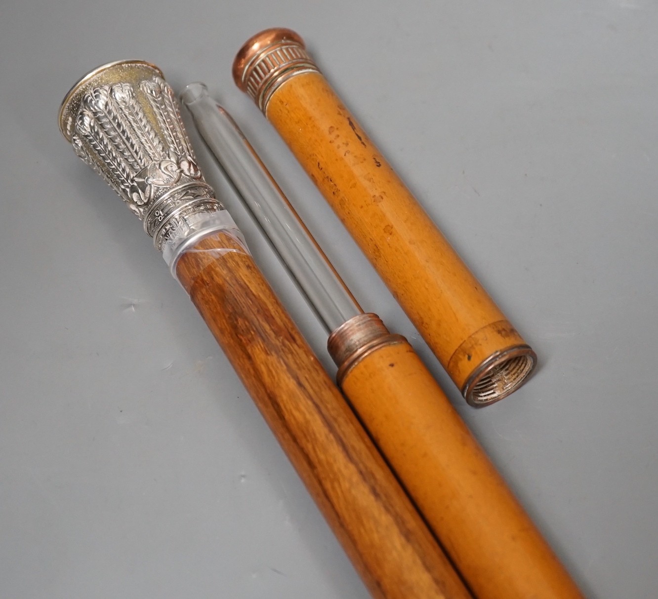 A silver handled cane win a horn tip and a copper handled flask cane, silver handled cane 94 cms long